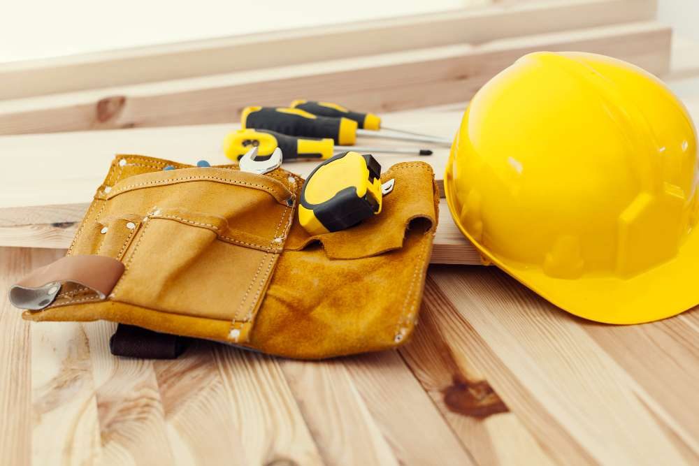 wooden-table-with-work-tools-helmet